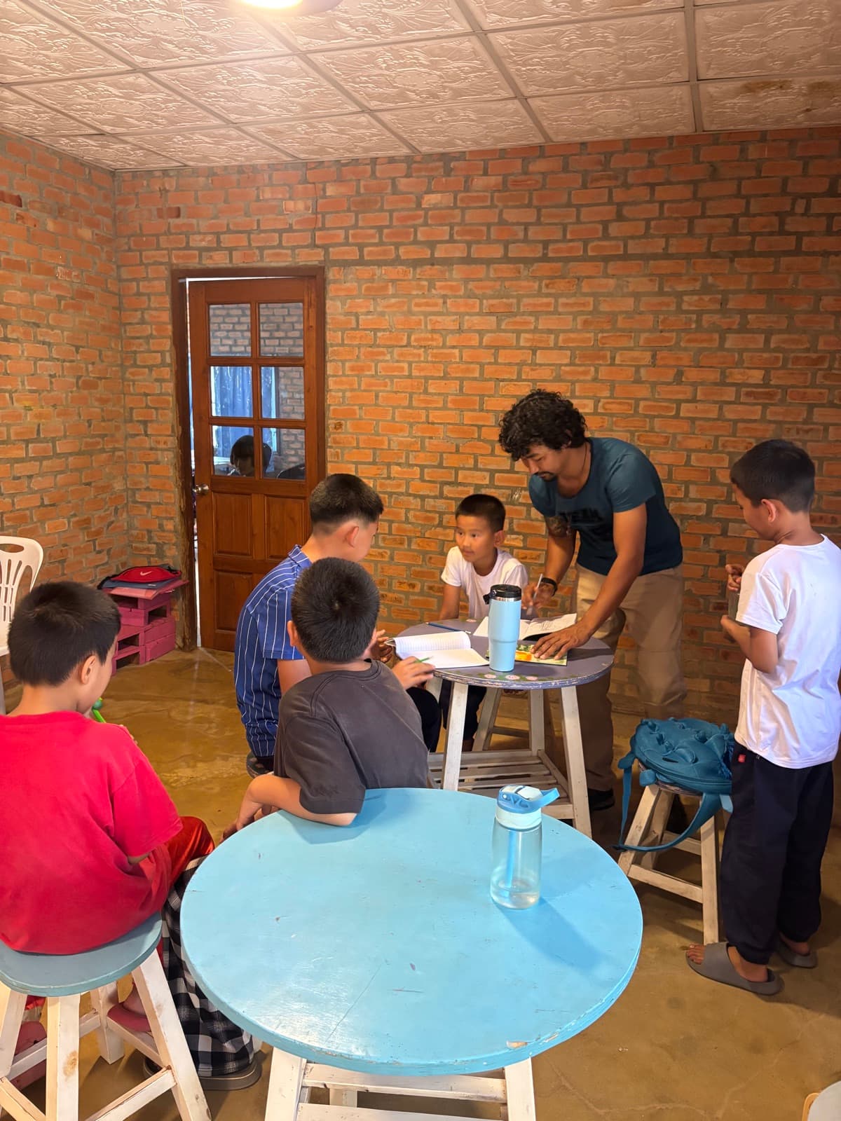 A teacher helping children with English lessons