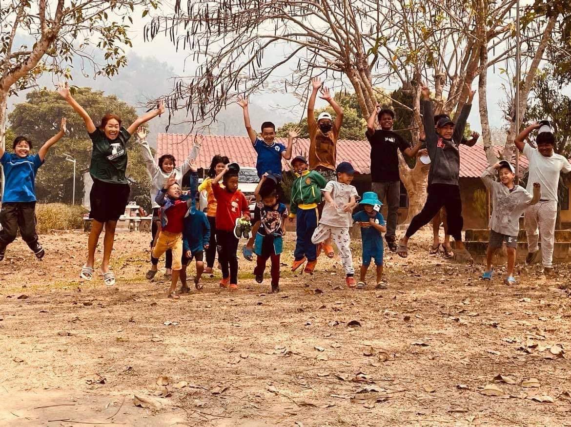Children joyfully jumping together at a LightUp camp