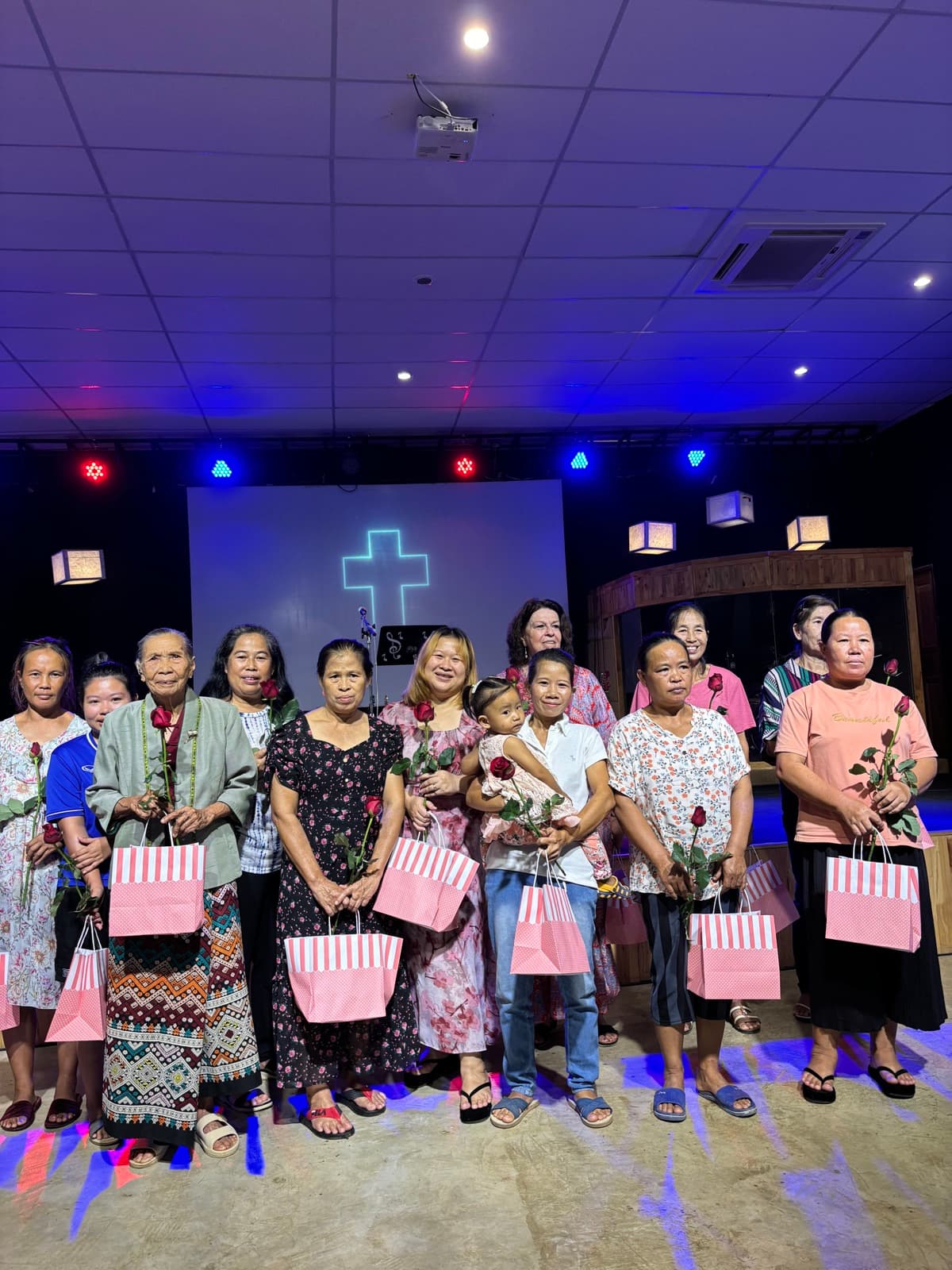 Women receiving flowers and gifts at a community ministry gathering